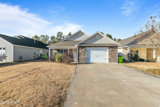 view of front of property featuring a garage, central air condition unit, and a front yard