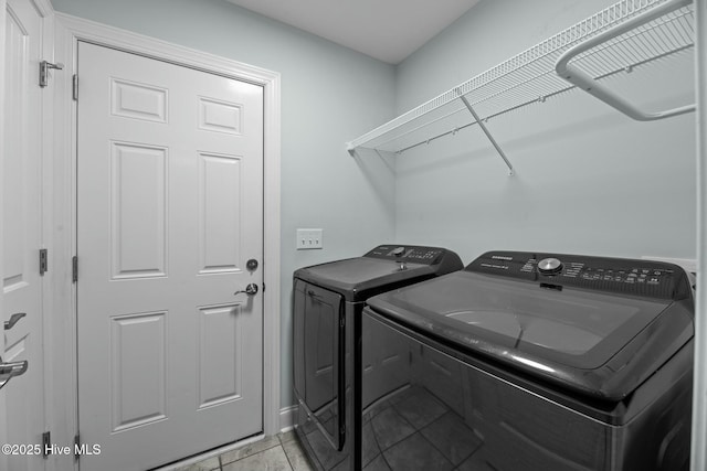 washroom featuring independent washer and dryer and light tile patterned flooring