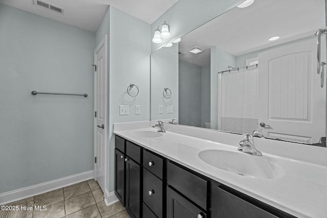 bathroom featuring toilet, tile patterned flooring, and vanity