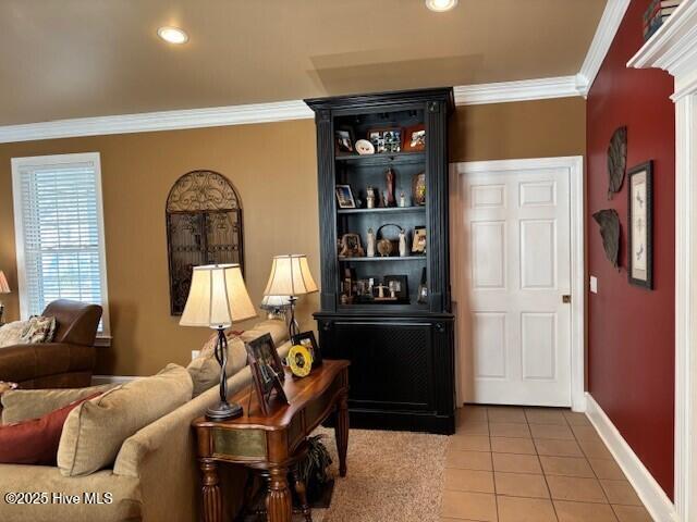 tiled living room featuring ornamental molding