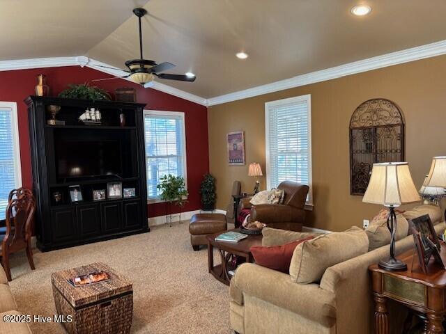 living room with crown molding, lofted ceiling, plenty of natural light, and carpet flooring