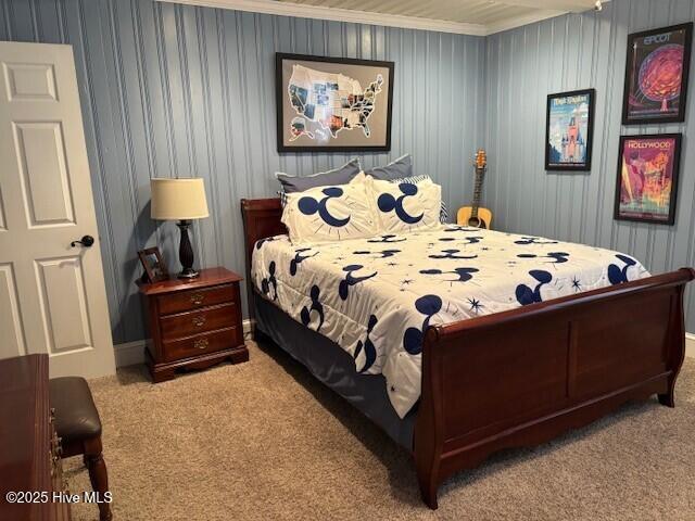 bedroom featuring ornamental molding and light carpet