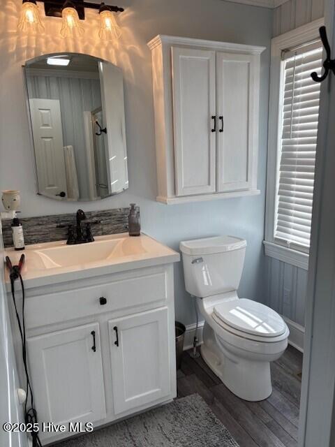 bathroom with vanity, hardwood / wood-style floors, and toilet