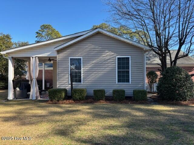 rear view of property with a yard