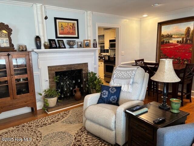 living room featuring hardwood / wood-style flooring and ornamental molding