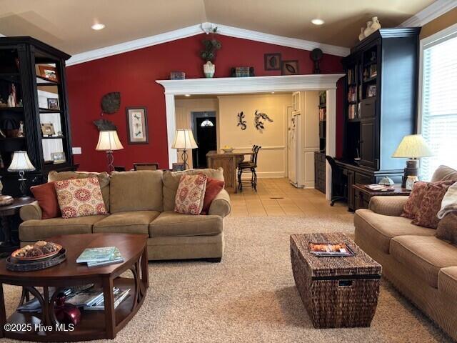 carpeted living room with crown molding and vaulted ceiling