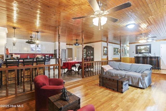 living room with ceiling fan, light hardwood / wood-style flooring, and wood ceiling