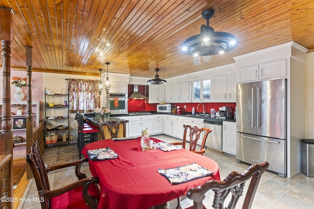 dining area with sink and crown molding