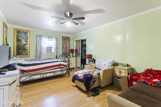 bedroom featuring ceiling fan, cooling unit, crown molding, and light wood-type flooring