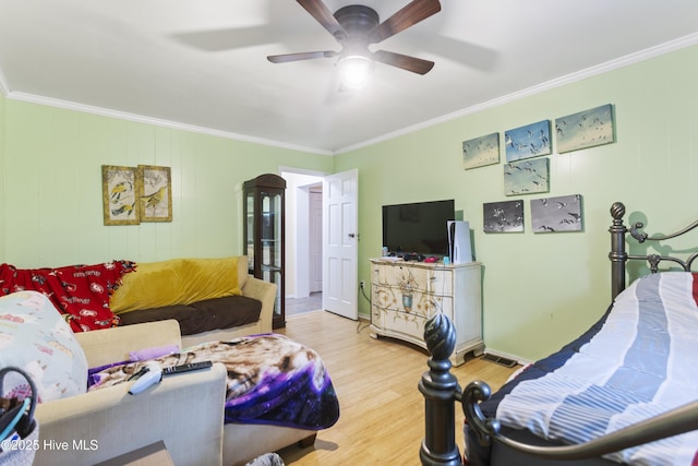 bedroom featuring ceiling fan, crown molding, and hardwood / wood-style flooring