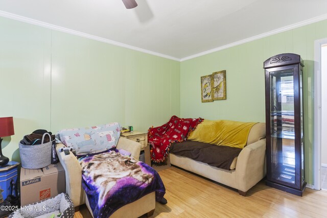 living room with hardwood / wood-style flooring, crown molding, and ceiling fan