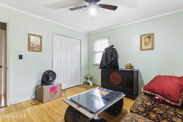 interior space featuring crown molding, hardwood / wood-style flooring, and ceiling fan