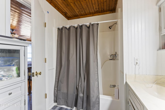 bathroom with wood ceiling, shower / bath combination with curtain, and vanity