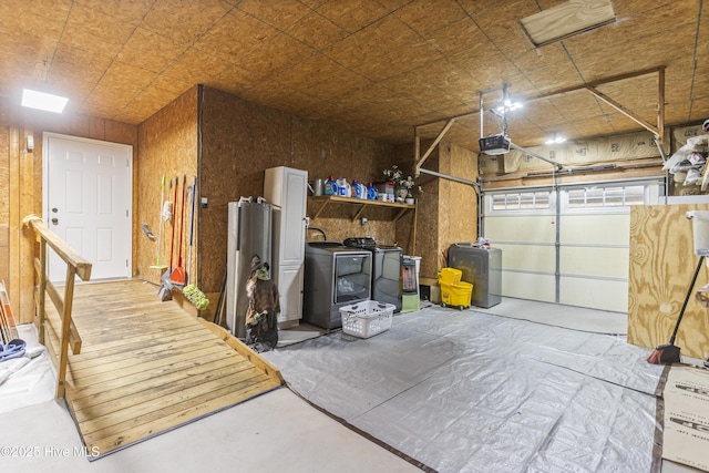 garage with washing machine and clothes dryer and a garage door opener