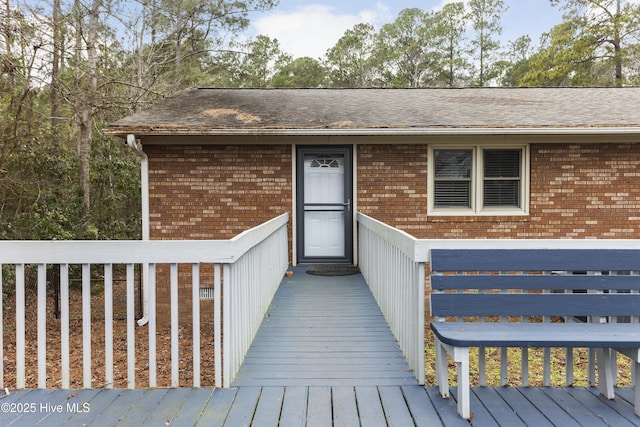 entrance to property featuring a wooden deck