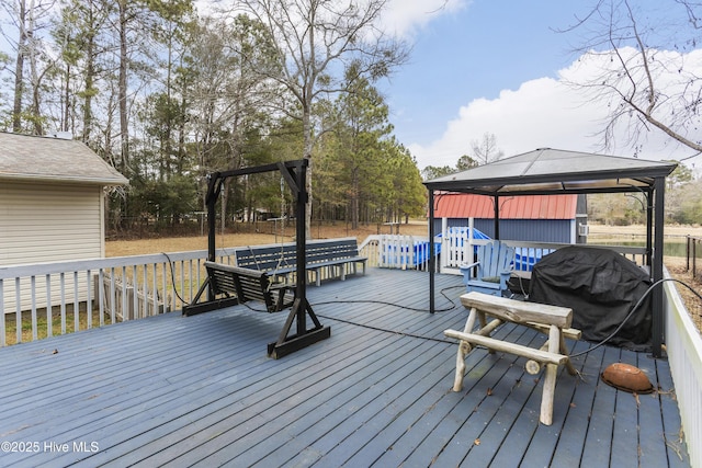 wooden deck with a gazebo and grilling area