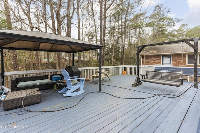 wooden terrace featuring a gazebo