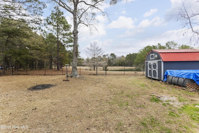 view of yard with a rural view and a shed