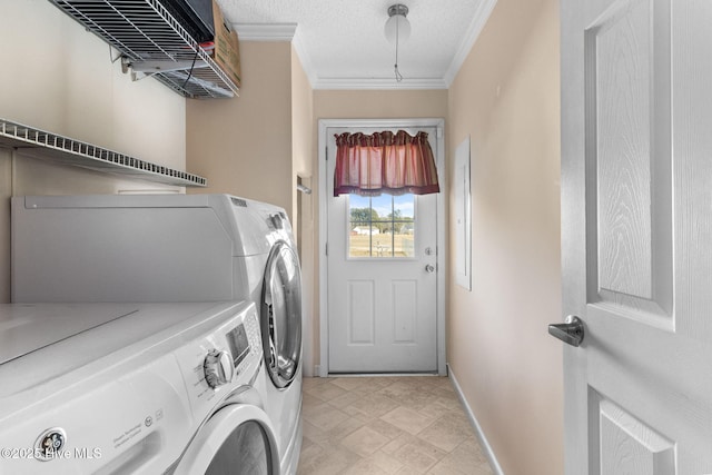 washroom with crown molding, a textured ceiling, and washer and clothes dryer