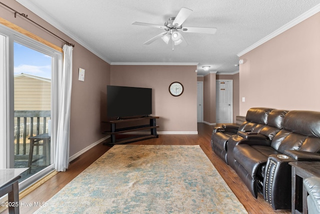 living room featuring crown molding, ceiling fan, dark hardwood / wood-style floors, and a textured ceiling