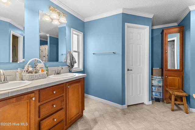 bathroom featuring vanity, ornamental molding, and a textured ceiling