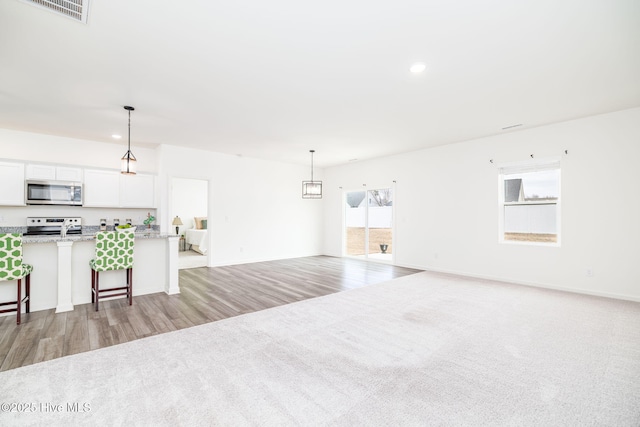 unfurnished living room with light colored carpet