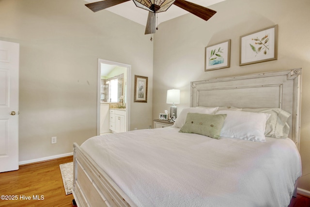 bedroom with ensuite bathroom and light wood-type flooring