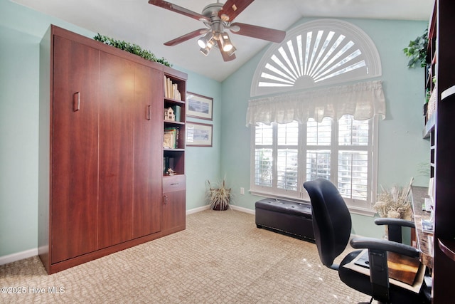 carpeted office featuring lofted ceiling and ceiling fan