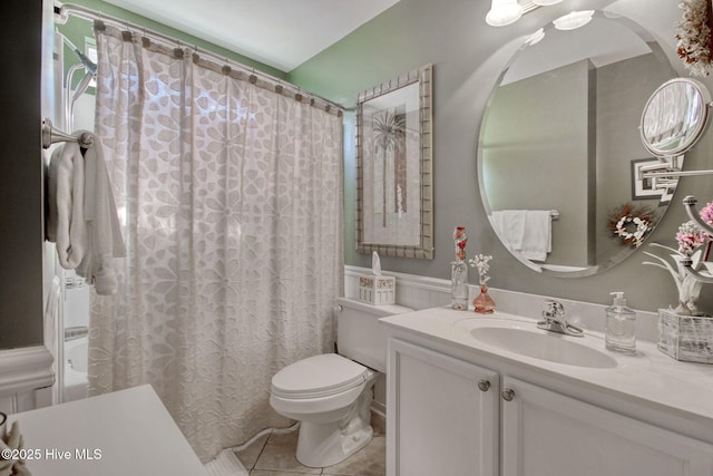 bathroom with vanity, curtained shower, tile patterned floors, and toilet