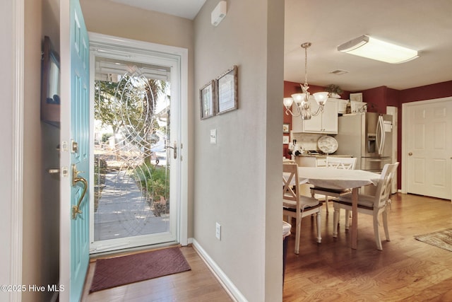 interior space featuring hardwood / wood-style floors and an inviting chandelier