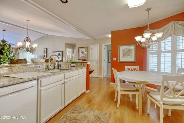 kitchen with pendant lighting, sink, white cabinets, a chandelier, and white dishwasher