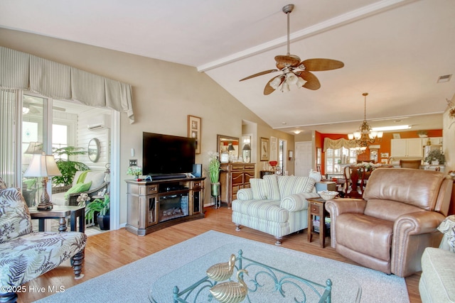 living room with ceiling fan with notable chandelier, light hardwood / wood-style flooring, and vaulted ceiling with beams