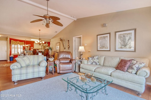 living room with ceiling fan with notable chandelier, hardwood / wood-style floors, and vaulted ceiling with beams