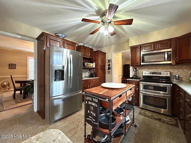 kitchen with ceiling fan, appliances with stainless steel finishes, backsplash, and dark brown cabinetry