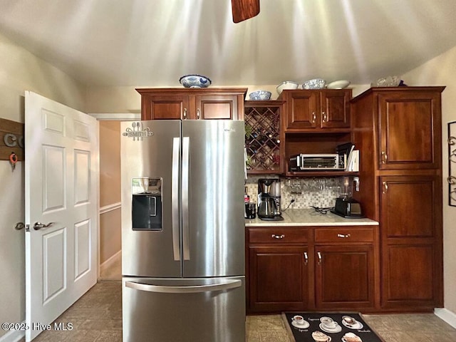 kitchen with decorative backsplash and stainless steel fridge with ice dispenser