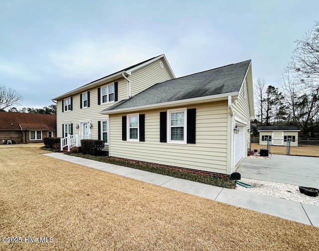 view of front of home with a garage and a front lawn