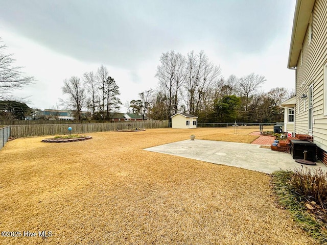 view of yard with a shed and a patio area