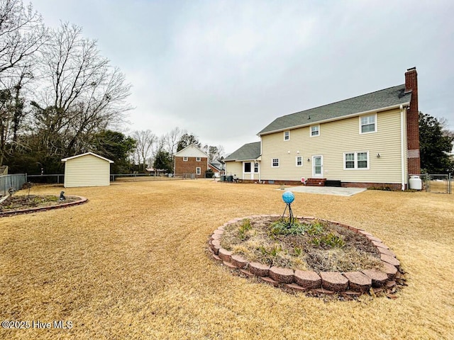 view of yard with a storage shed and a patio area