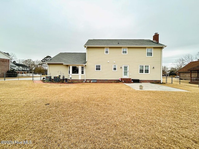 back of property with a patio and a lawn