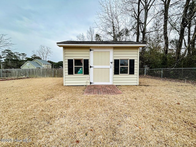 view of outdoor structure featuring a lawn