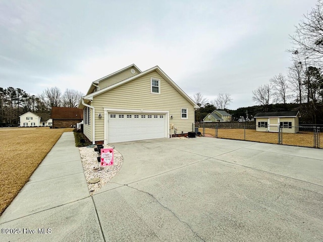 view of side of property with a garage and a lawn