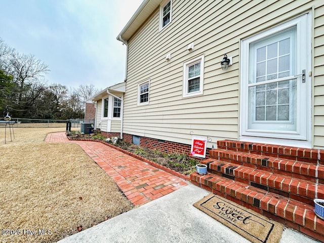 view of property exterior featuring central AC unit, a yard, and a patio