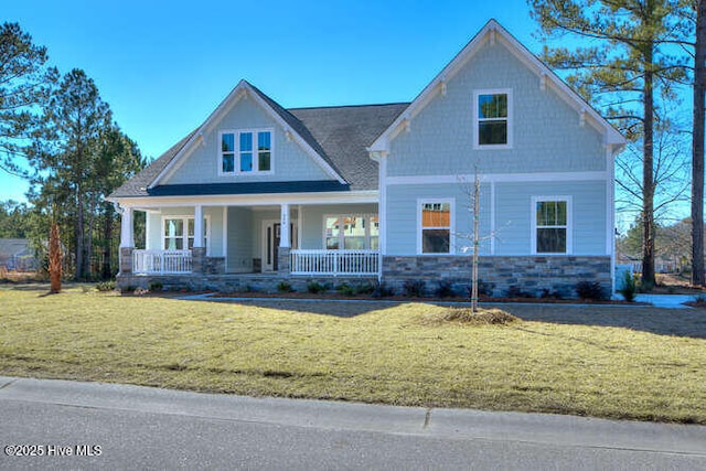 craftsman-style house with a front yard and a porch