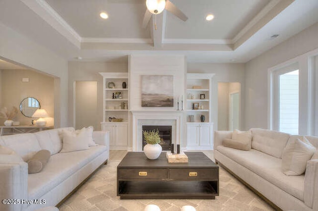 living room featuring beam ceiling, ornamental molding, built in features, and ceiling fan