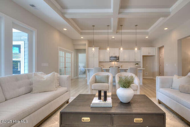 living room featuring beamed ceiling, coffered ceiling, and light hardwood / wood-style floors