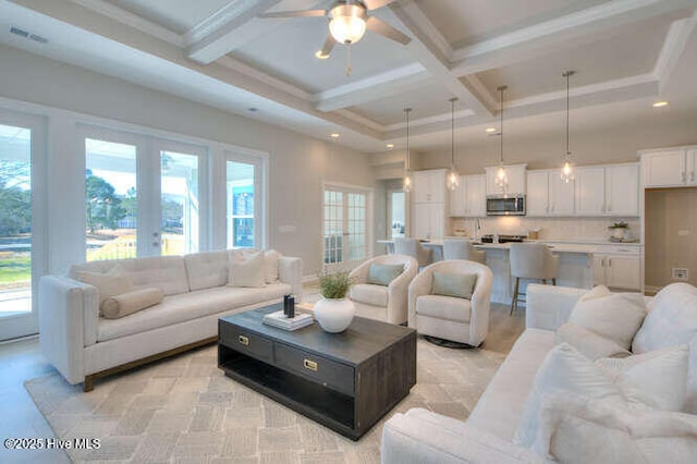 living room with french doors, ceiling fan, coffered ceiling, and beam ceiling