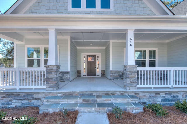 view of exterior entry featuring a porch