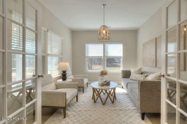 carpeted living room featuring french doors