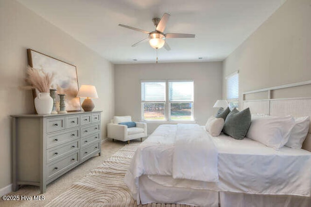 bedroom featuring light colored carpet and ceiling fan