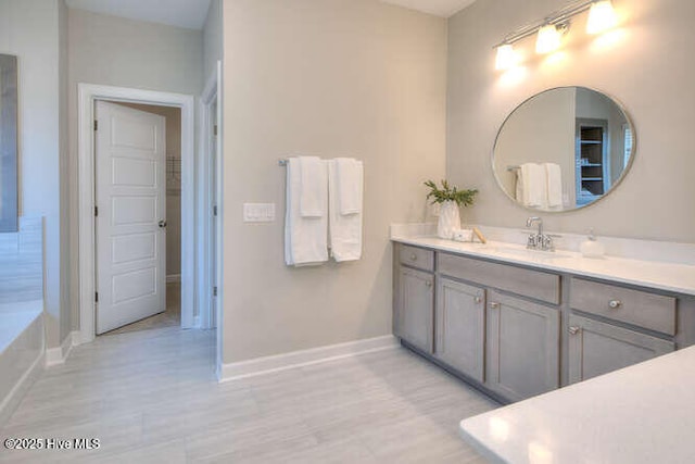 bathroom with vanity and a tub